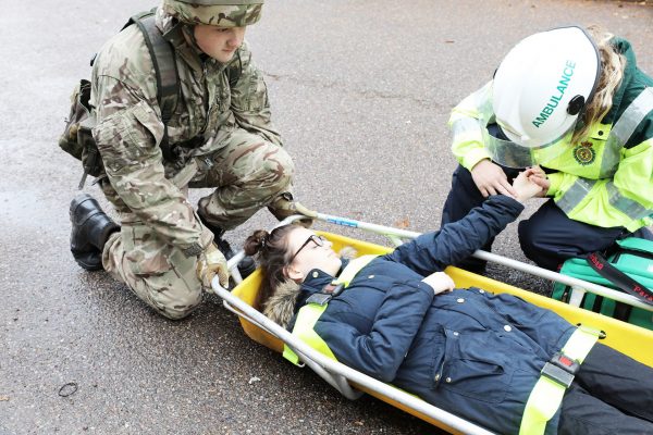 Military academy students practicing a stretcher drill