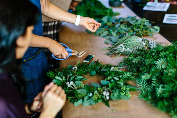 People making Christmas wreaths and garlands